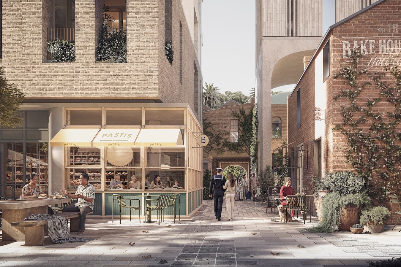 An intimate laneway leads toward the boutique hotel entry, where a softly curved portico frames arrival and gives the refurbished Bake House its own quiet moment of prominence.